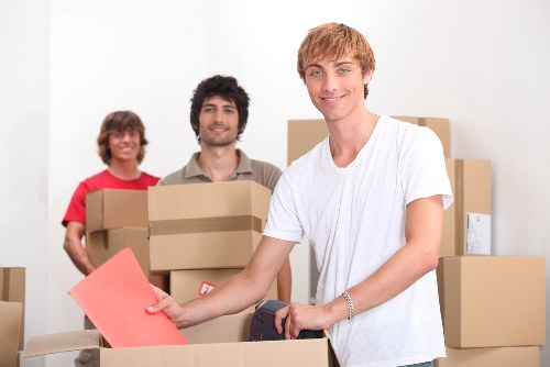 Movers handling furniture carefully in a Kensington home